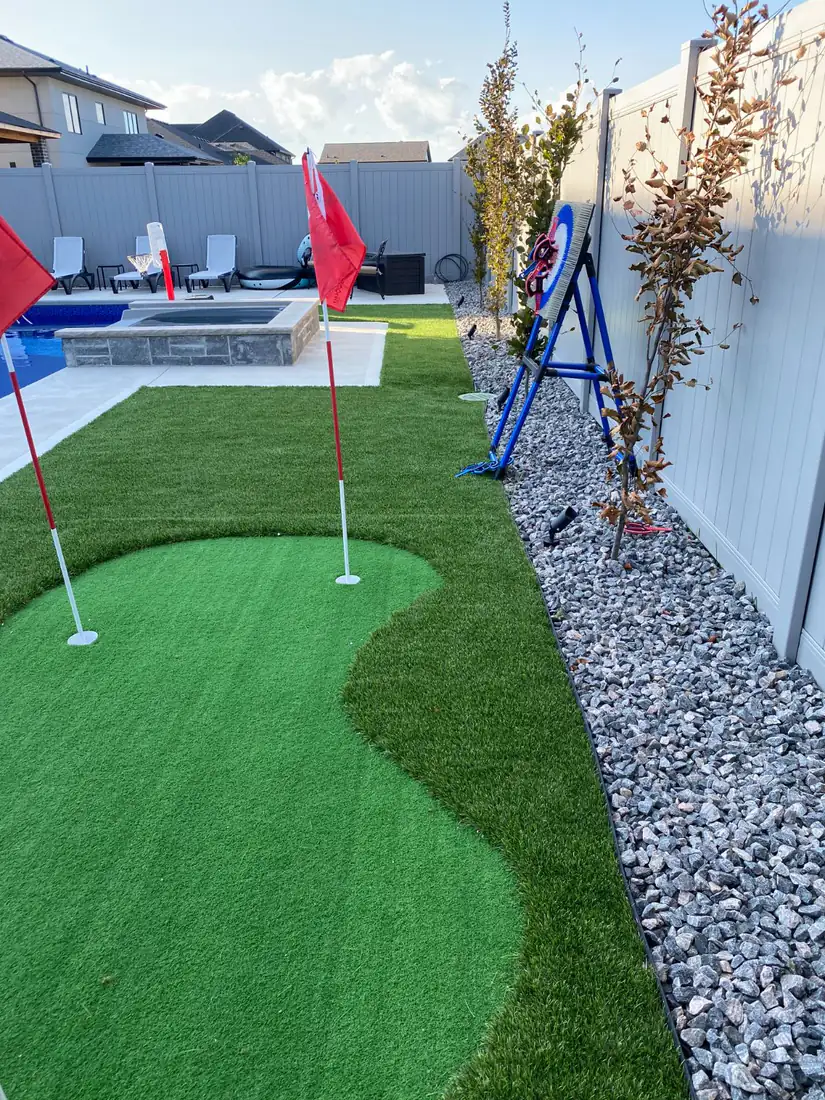 Turf putting green along the fence