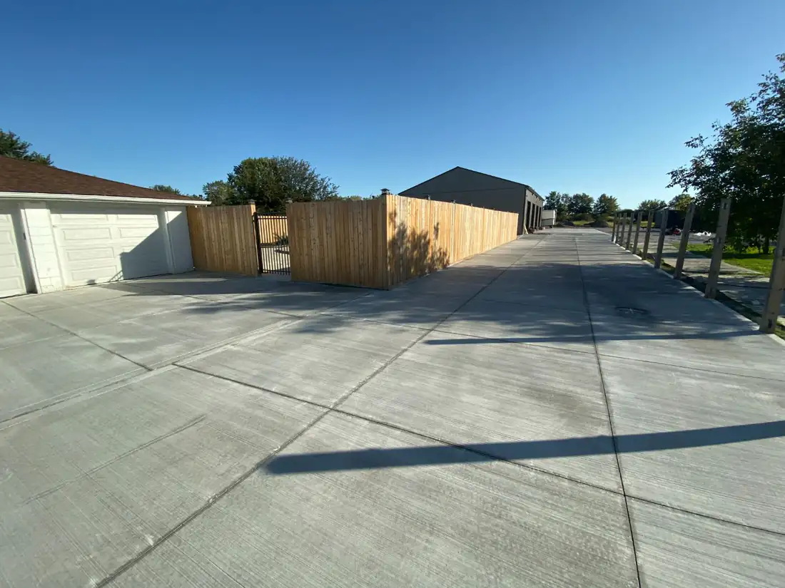 Concrete laneway with a wood fence